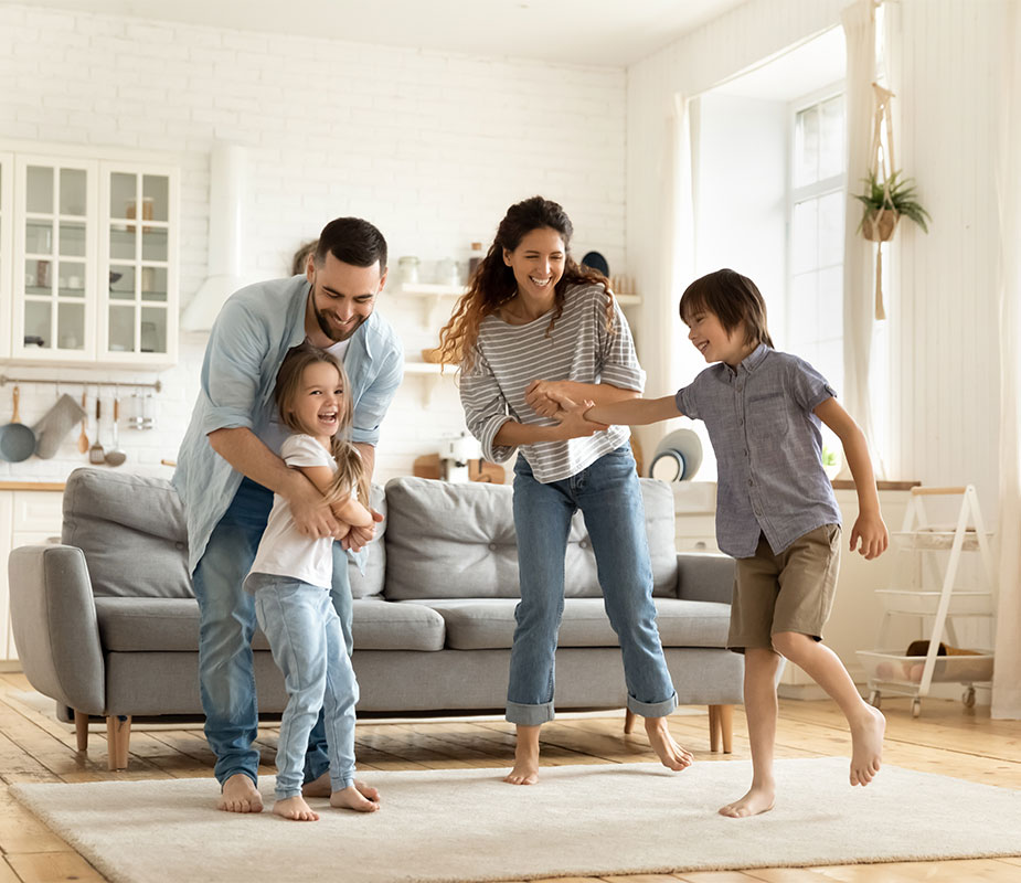 Family dancing in new home